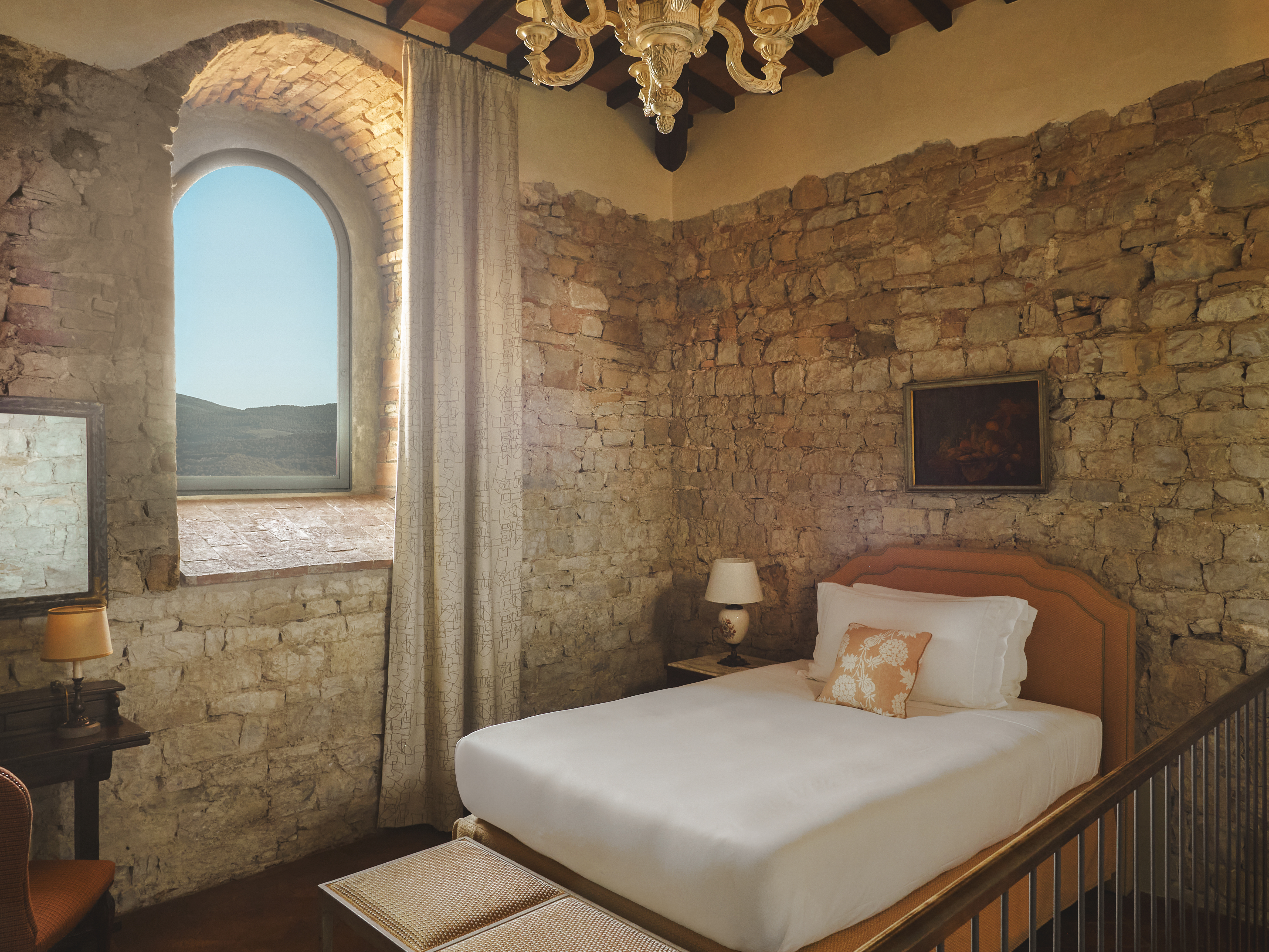 Castello di Casole guest room interior with ancient walls