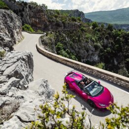 Pink Lamborghini on a cliffside road above the Verdon Gorge
